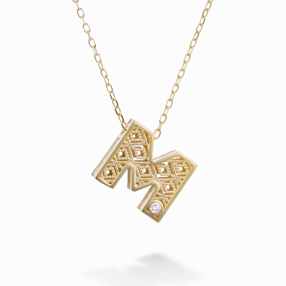 Nihama cl 18k bokstav m gult guld diam. ct.0,01 NDLETMO1